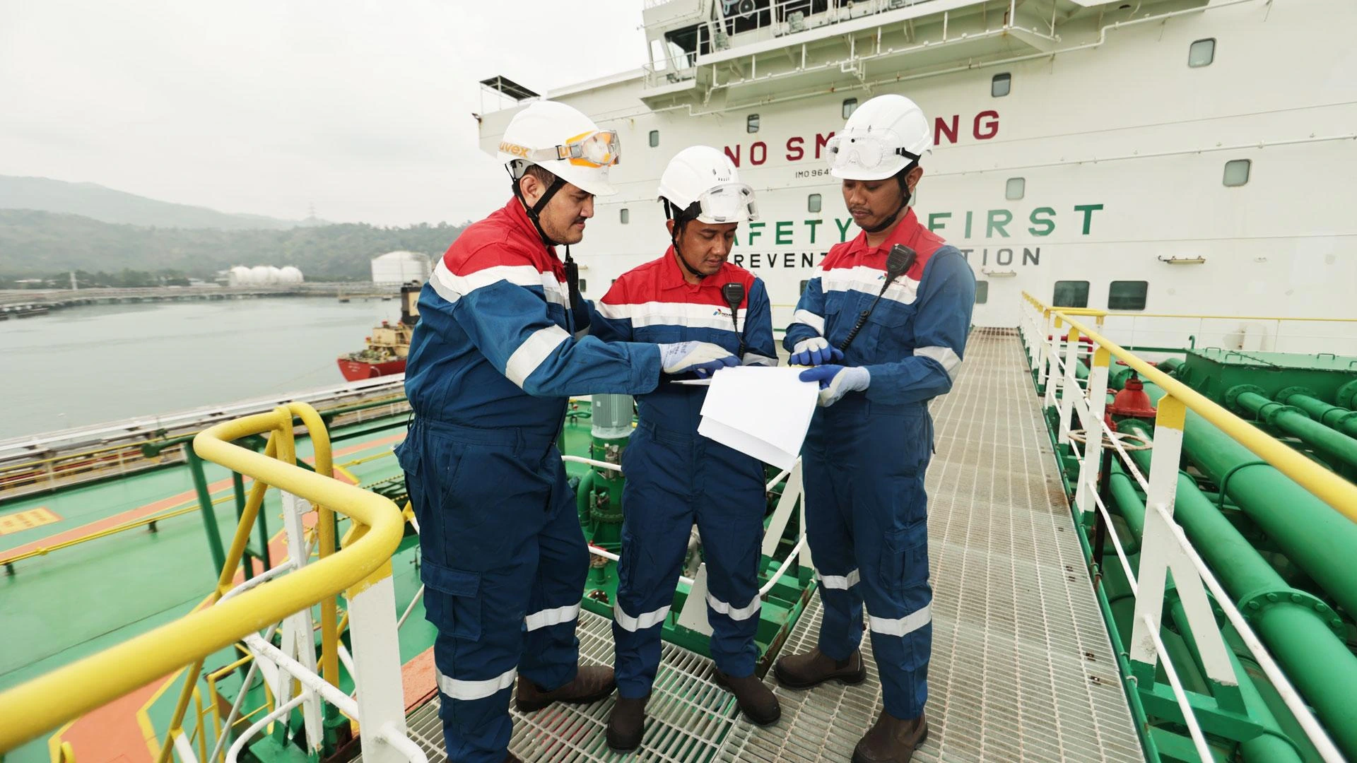 Crew members in safety equipment working onboard